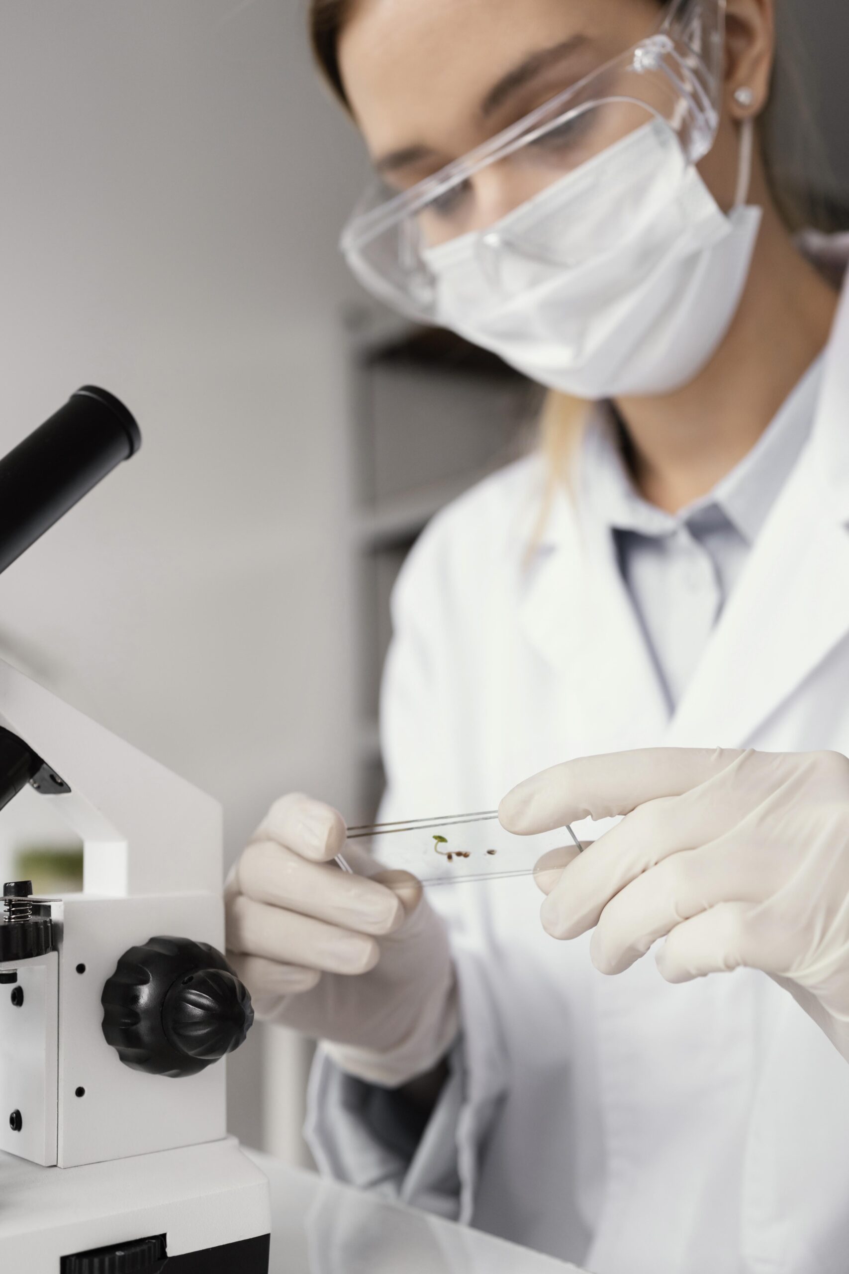 close-up-researcher-holding-slide-glass