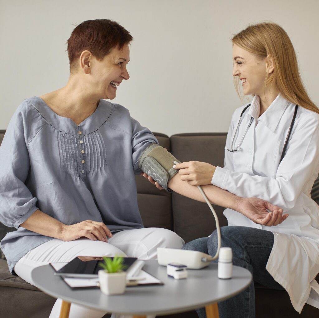 front-view-covid-recovery-center-female-doctor-checking-elder-patient-s-blood-pressure