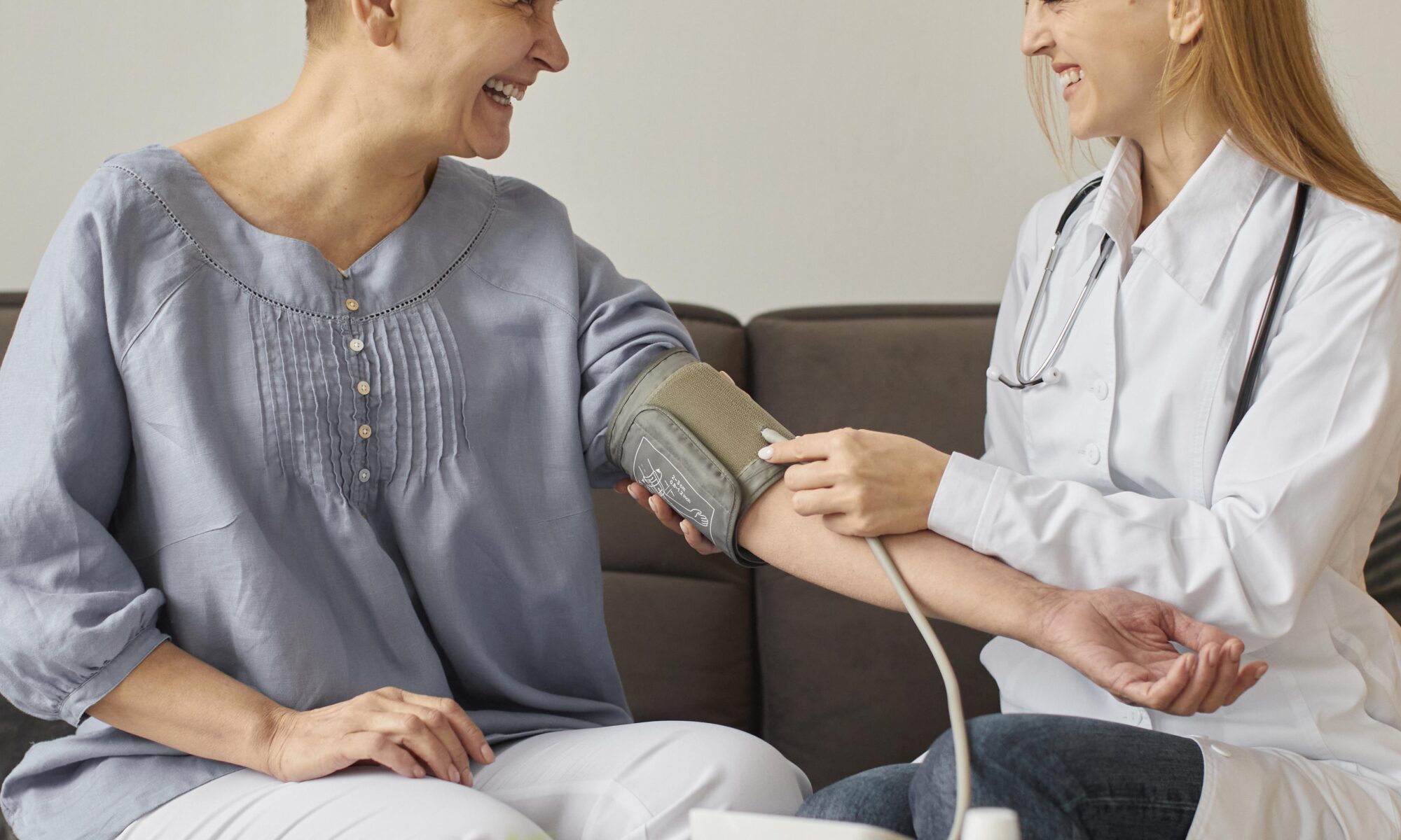 front-view-covid-recovery-center-female-doctor-checking-elder-patient-s-blood-pressure