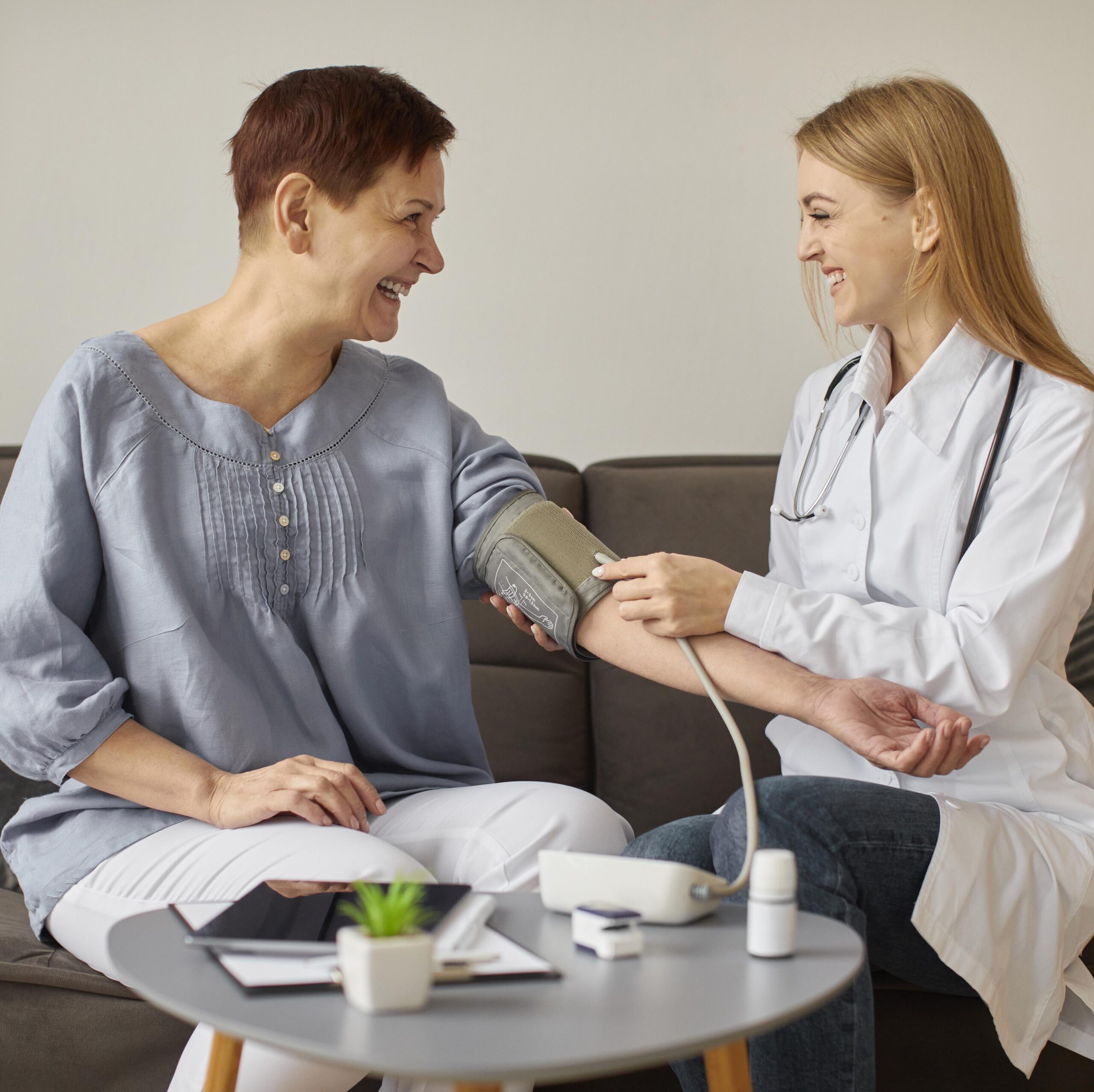 front-view-covid-recovery-center-female-doctor-checking-elder-patient-s-blood-pressure